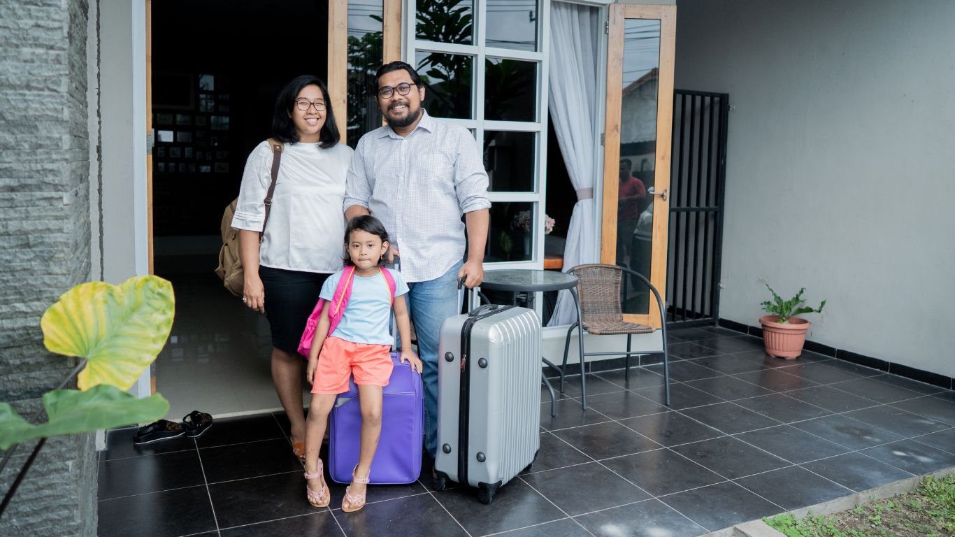 Melbourne family home with a suitcase and backpack on the front porch, ready for a holiday departure.