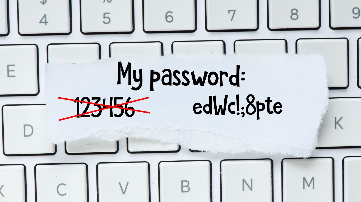 a keyboard with a basic, easy-to-guess password scratched out, and a more comprehensive password written